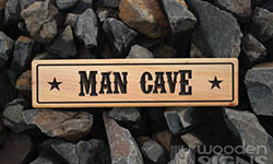 man cave macrocarpa sign with stars on the end and a boarder 500 x 140mm